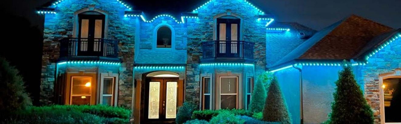 Home with Brighter Nights by TrueSpec programmable LED roofline lighting illuminated in teal at night